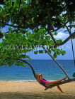 DOMINICAN REPUBLIC, North Coast, Playa Dorada beach, tourist relaxing on tree branch, DR339JPL