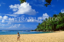 DOMINICAN REPUBLIC, North Coast, Playa Grande beach, boy walking along, DR442JPL