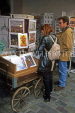France, PARIS, Montmatre, visitors browing through prints & postcards stand, FRA1620JPL