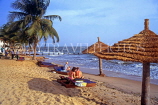 GAMBIA, Banjul, beach with coconut trees, sunbathers and thatched sunshades, GAM901JPL