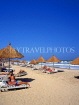 GAMBIA, Kotu Beach, sunbathers and thatched sunshades, GAM831JPL
