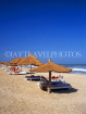 GAMBIA, Kotu Beach, sunbathers and thatched sunshades, GAM835JPL