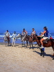 GAMBIA, Kotu Beach, tourists saddled up for horse riding, GAM841JPL