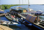 GAMBIA, Liman, dug out canoes and boats by the pier, GAM943JPL