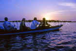 GAMBIA, River Gambia, tourists in dug out canoe (pirogue) on bird watching tour, dawn, GAM1045JPL