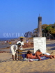 GAMBIA, beach scene, fruit sellers talking to sunbathers, GAM899JPL