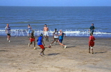 GAMBIA, beach scene, tourists and locals paying football, GAM913JPL