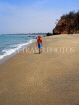 GAMBIA, boy (tourist) walking along beach, GAM843JPL