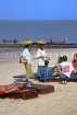 GAMBIA, fruit sellers and tourists on beach, GAM910JPL