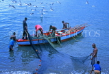 GRENADA, fishermen in boat, sorting out nets, GRE356JPL
