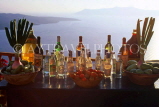 Greek Islands, SANTORINI, restaurant table with uzo, wine, vinegar & oils, GIS641JPL