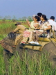 INDIA, Assam, Kaziranga National Park, tourists on elephant safari, taking pictures, IND1447JPL