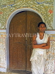 INDIA, Assam, Majuli Island, Vishnavaite monk standing by monastery doorway, IND1455JPL