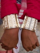 INDIA, Assam, Rongali Bihu Assamese New Year festival, gold bracelets on dancer, IND1463JPL