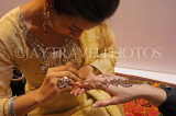INDIA, Rajasthan, artist painting Henna design on tourist's hand, Mehndi art, IND1551JPL