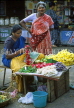 INDIA, South India, MADRAS, vendor making flower garlands (for temple offerings), IND941JPL