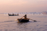 INDIA, Uttar Pradesh, VARANASI, River Ganges, woman rowing small boat, IND592JPL