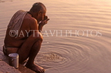 INDIA, Uttar Pradesh, VARANASI, pilgrim washing at River Ganges, at dawn, IND597JPL