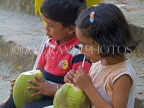 INDIA, West Bengal, Calcutta, brother and sister sipping coconut water, IND1373JPL