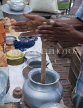 INDIA, West Bengal, Calcutta, roadside food stall, hands busy making a lassi, IND1400JPL