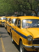 INDIA, West Bengal, Calcutta, row of vintage Ambassador taxis at rush hour, IND1402JPL