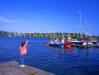 IRELAND, County Cork, KINSALE harbour, boats and girl at pier, IRE218JPL