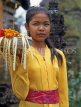 Indonesia, BALI, village girl at temple, with flower offerings, BAL545JPL