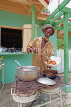 JAMAICA, Montego Bay, Rasta vendor serving takeway food, JM377JPL