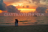 JAMAICA, Negril, 7 Mile Beach, sunset, with people walking, JM312JPL