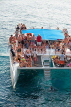 JAMAICA, Negril, Rick's Cafe, tourists in party boat, catamaran cruise, JM340JPL
