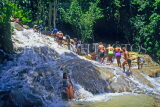 JAMAICA, Ocho Rios, tourists walking upstream Dunn's River Falls, JM213JPL
