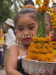LAOS, Luang Prabang, Lao girl with flowers at Songkran New Year parade, LAO48JPL