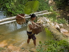 LAOS, Muang Ngoi, farmer with baskets, and shading herself with giant taro leaf, LAO77JPL