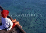 MALDIVE ISLANDS, Velassaru Island, boy watching fish from pier, MAL121JPL