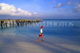 MALDIVE ISLANDS, Velassaru Island, pier and boy paddling, MAL36JPL