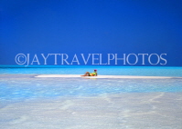 MALDIVE ISLANDS, holidaymaker sunbathing on strip of sand, shallow water, MAL252JPL