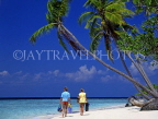 MALDIVE ISLANDS, typical island, couple along beach, leaning coconut trees, MAL702JPL