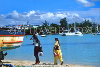 MAURITIUS, North Coast, Grand Bay, people walking along beach, MRU183JPL
