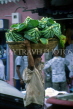MAURITIUS, Port Louis, main market, vendor with vegetable basket on head, MRU296JPL