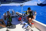 MEXICO, Yucatan, COZUMEL, couple of divers preparing for dive from boat, MEX499JPL