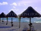MEXICO, Yucatan, Playa Del Carmen, thatched sunshades along beach, MEX640JPL