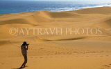 NAMIBIA, Swakopmund, Skeleton Coast, Naukluft Desert sand dunes, man photographing, NAM156JPL