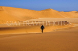 NAMIBIA, Swakopmund, Skeleton Coast, Naukluft Desert sand dunes, man walking, NAM157JPL