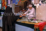 OMAN, Muscat, Al Muttrah, Old Souk, woman purchaing at jewellery stall, OMA223JPL