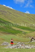PERU, Chupani, Andean Mountain scenery, woman walking, PER67JPL