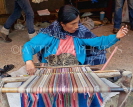 PERU, Parobamba, traditional textile weaving, woman working with with loom, and cat, PER99JPL