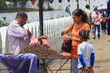 SRI LANKA, Kandy, Kandy lakeside, fruitseller, people buying Velvet Tamarind (Gal Siyambala), SLK3954JPL