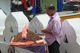 SRI LANKA, Kandy, Kandy lakeside, fruitseller, selling Velvet Tamarind (Gal Siyambala), SLK3956JPL