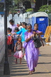 SRI LANKA, Kandy, Kandy lakeside, people walking along promenade, SLK3896JPL
