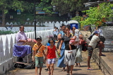 SRI LANKA, Kandy, Kandy lakeside, people walking along promenade, SLK3952JPL